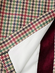 Macro view of velvet lining and houndstooth fabric detail on women blazer jacket