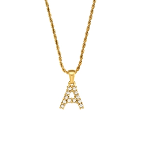 Macro detail of gold twisted rope chain and letter A pendant with sparkling zircon stones