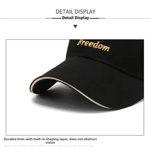 Macro shot of gold Freedom embroidery on a black baseball cap with contrast piping