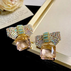 Elegant pink bow crystal earrings with rectangular champagne pendants in luxury gold finish