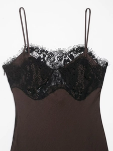Detail of dark brown satin camisole featuring delicate black eyelash lace neckline trim