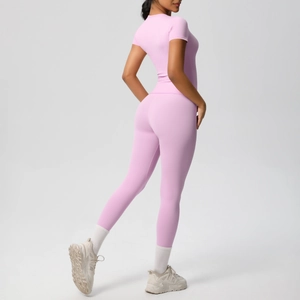 Rear view of pink short sleeve top and high waist leggings yoga set on model