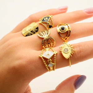 Detailed view of six gold-plated titanium evil eye rings with enamel and rhinestones