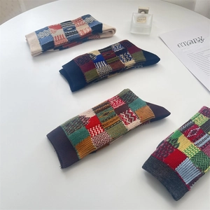 Detail of vintage patchwork checkered cotton socks with colorful geometric patterns