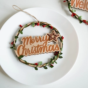 Wooden Christmas door wreath with Merry Christmas lettering and green foliage decor