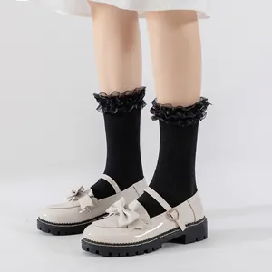 Beige patent leather Mary Jane shoes with double bow detail and platform soles
