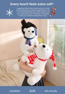 Close-up of soft plush polar bears wearing festive red and blue Christmas scarves