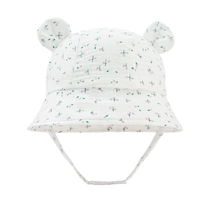 Close-up of white baby sun hat with purple floral pattern and cute 3D bear ears