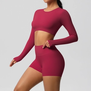 Detailed side view of high-waisted dark red yoga set with long sleeve crop top and shorts