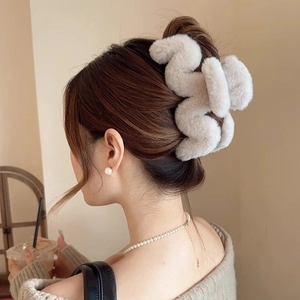 Detail einer großen cremefarbenen Plüsch-Haarklammer für eine elegante Hochsteckfrisur