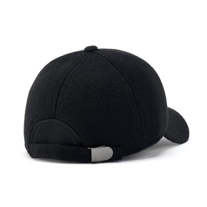 Macro view of adjustable metal buckle and wool texture on black winter baseball cap
