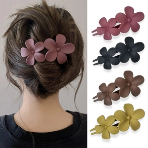Detailed view of matte flower hair clips in pink purple, black, coffee and yellow green