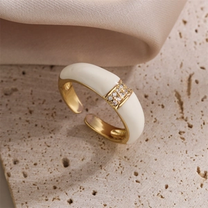 Close-up of 18K gold-plated open ring with white enamel and sparkling zircon stones