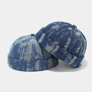 Detail of blue denim docker hats with white jacquard texture and vintage washed finish