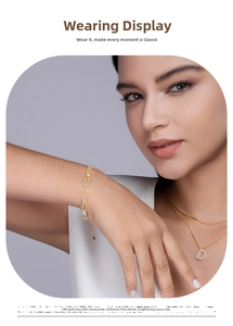 Detail of 18K gold paperclip chain bracelet with sparkling moissanite stones on wrist
