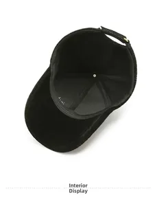 Interior view of black corduroy baseball cap showing sweatband and adjustable metal strap