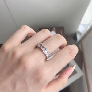 Macro shot of silver S925 ring with channel-set rectangular zircon stones on hand