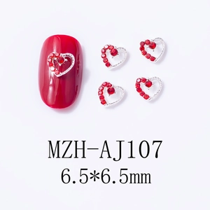 Macro view of 6.5mm red heart nail gems with silver alloy base on red manicure