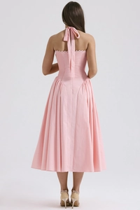Detail of pink halter neck midi dress featuring open back design and linen-like texture