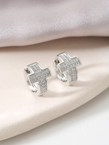 Detailed close-up of silver cross hoop earrings with micro-pave cubic zirconia crystals