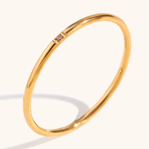 Minimalist 18K gold plated stainless steel ring with a small sparkling centerpiece stone