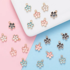 Detail of colorful enamel cherry blossom charms with rhinestones for DIY jewelry making