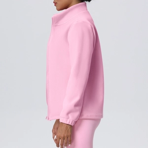Close-up of pink fleece jacket with stand collar and zipper detail for sports