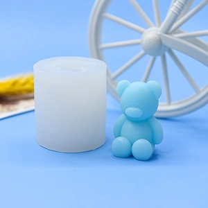 Detail showing white translucent silicone bear mold with finished blue 3D teddy bear