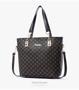 Detail view of large tote bag featuring golden hardware and M-logo printed texture