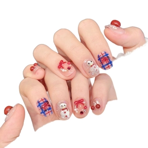 Christmas snowman press-on nails with plaid bow and festive 3D charms design