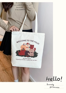 Detail of the cute Kitten Family cartoon print on a white canvas tote bag