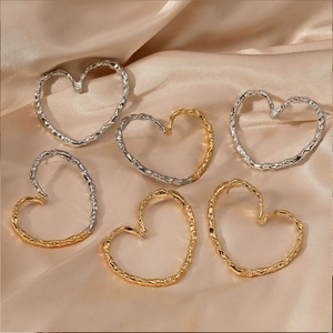 Three pairs of heart-shaped hollow earrings with irregular hammered texture in gold and silver