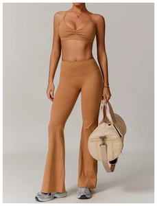 Close-up of tan quick-dry yoga set featuring cross-back bra and flared leggings texture
