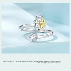 Macro detail of 925 sterling silver mother and child hug ring with heart zircon