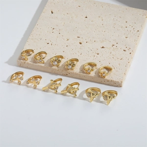 Set of 12 dainty gold floral and cross earrings with crystal accents on stone