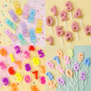 Various colorful number candles for birthday cakes including donut and macaron styles
