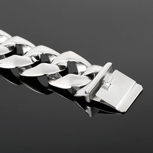 Detailed macro view of silver Cuban chain bracelet with secure dual-locking clasp