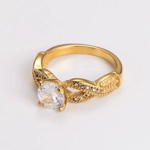 Macro shot of gold-plated ring with a large round zircon and twisted pave-set band