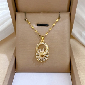 Detailed view of a gold flower necklace with zircon stones in a luxury gift box