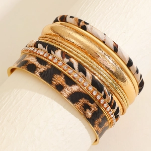 Detail of multi-layer leopard print leather bracelet set with gold bangles and rhinestones