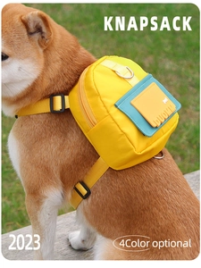 Close-up of a yellow nylon dog backpack with blue pocket on a Shiba Inu outdoors
