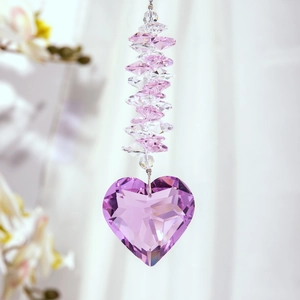 Macro shot of a faceted pink crystal heart suncatcher with transparent glass beads