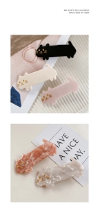 Close-up of minimalist calico cat hair clips made of colorful acetate cellulose material