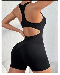 Close-up of the cutout back design on a black seamless yoga jumpsuit with ribbed texture