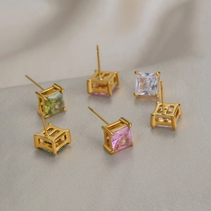 Close-up of square cut zircon earrings in pink, green, and clear with 18K gold plating