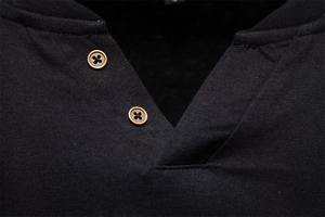Close-up of black cotton knit V-neck henley collar with two vintage bronze buttons