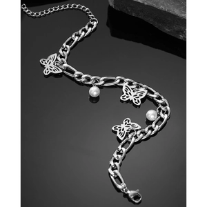 Silver Figaro chain bracelet with butterfly charms and white pearls on black mirror