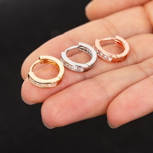 Detailed view of three-color small hoop earrings with fine cubic zirconia inlay