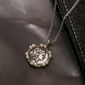 Detailed close-up of retro Athena coin pendant with white pearls and sparkling rhinestones