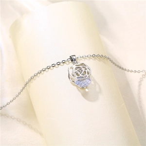 Elegant silver rose flower pendant necklace with zircon stone on a beige display stand